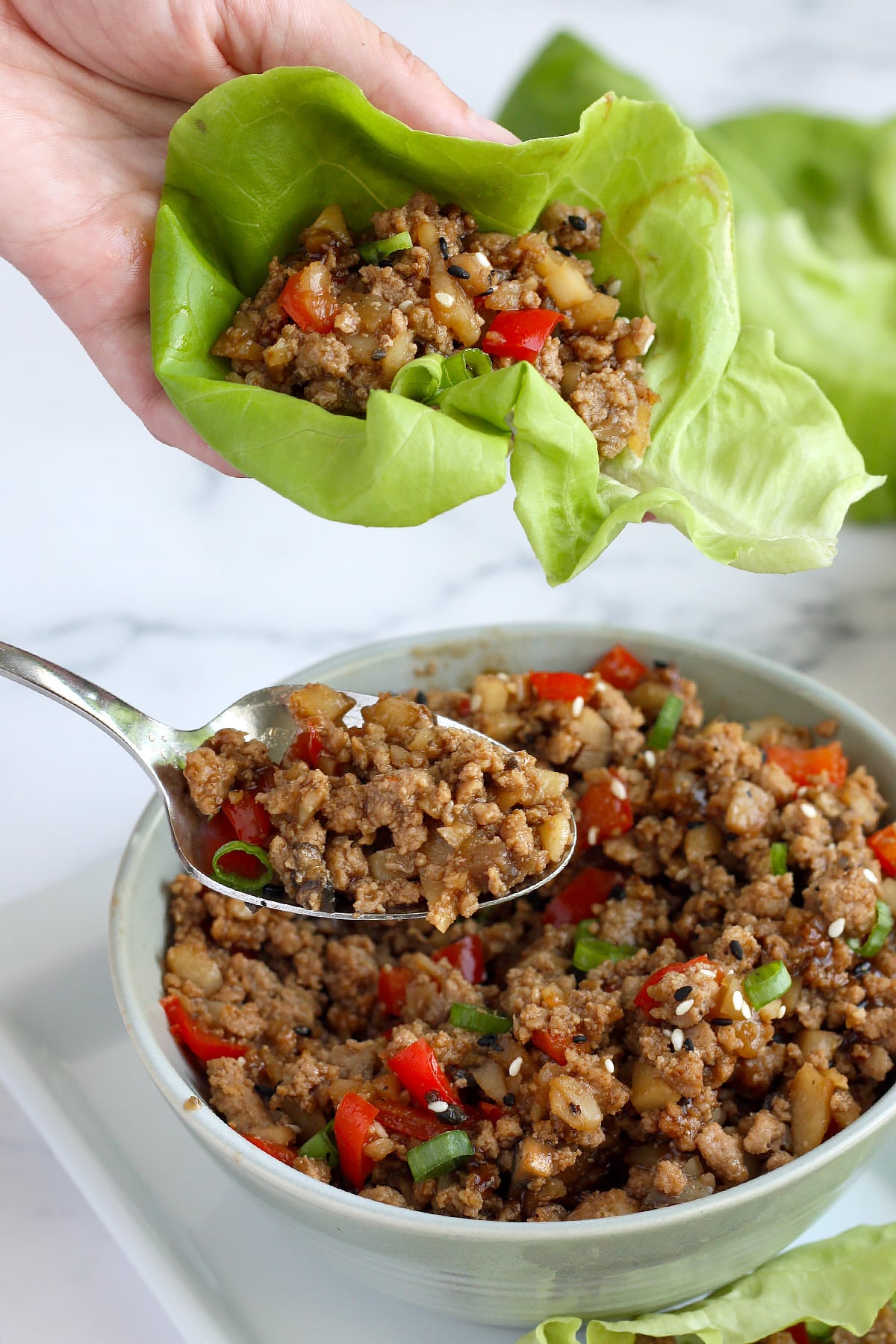 a close up image of asian lettuce wraps with ground turkey in butter lettuce