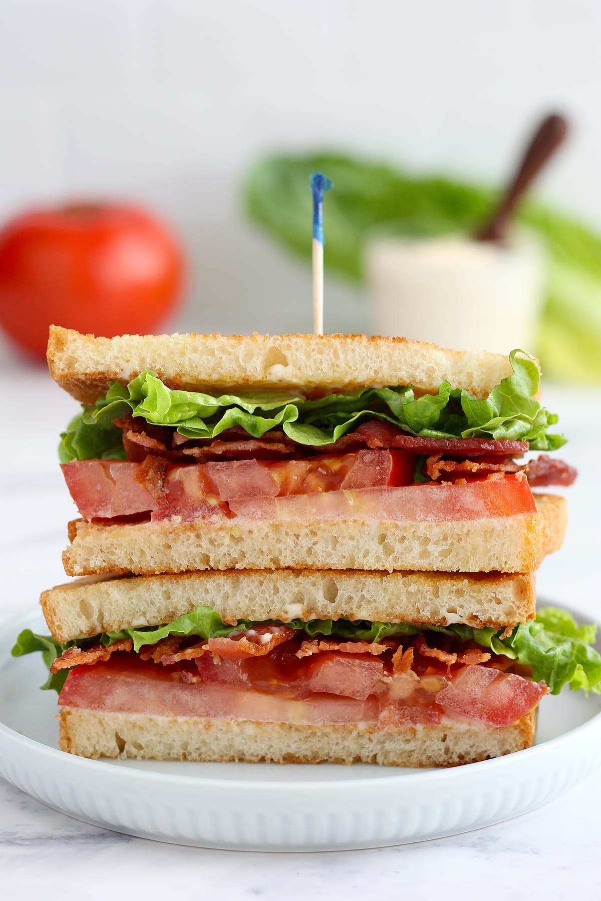 the best blt sandwich on toasted bread, cut in half with a toothpick