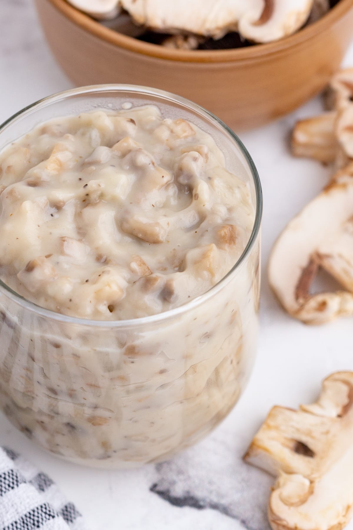 homemade cream of mushroom soup with fresh mushrooms in a small glass jar