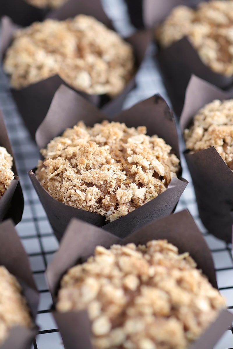 pumpkin streusel muffins in brown paper liners on a cooling rack