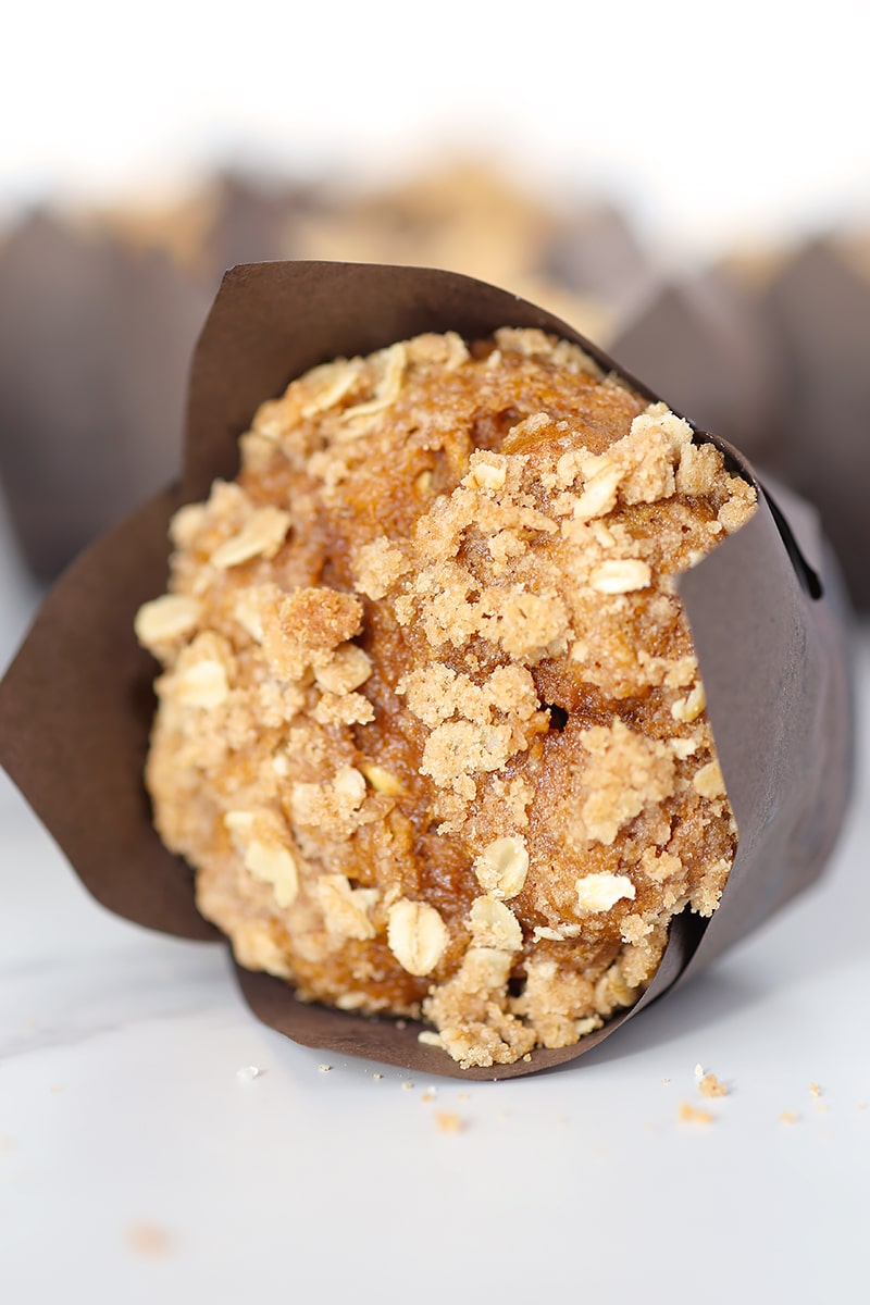 a close up image of the top of a pumpkin streusel oat muffin