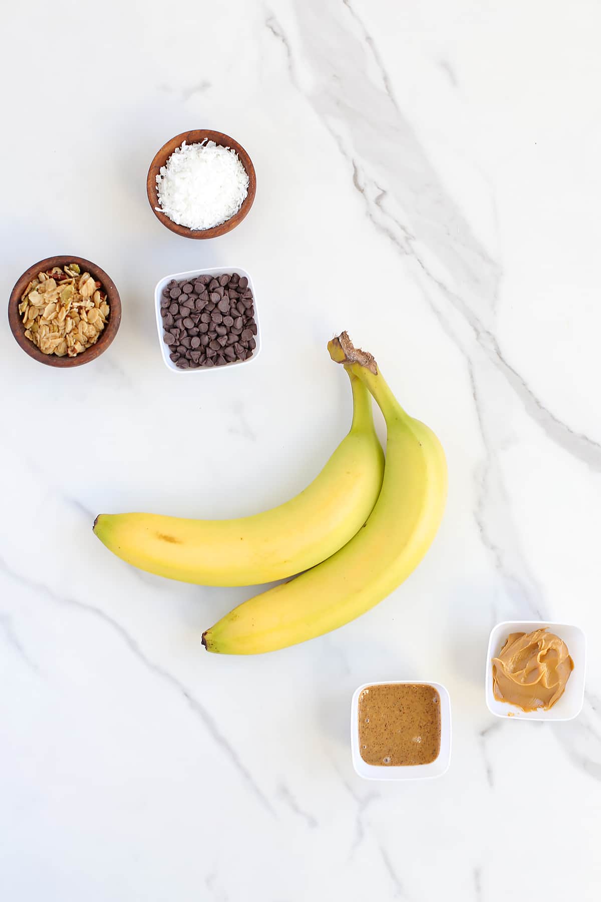 ingredients you need to make banana sushi snack displayed on a marble countertop