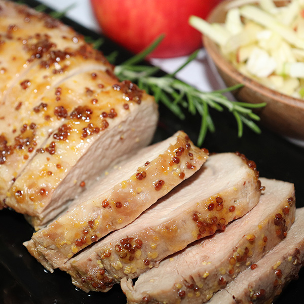 Sliced maple glazed pork loin with apple slaw