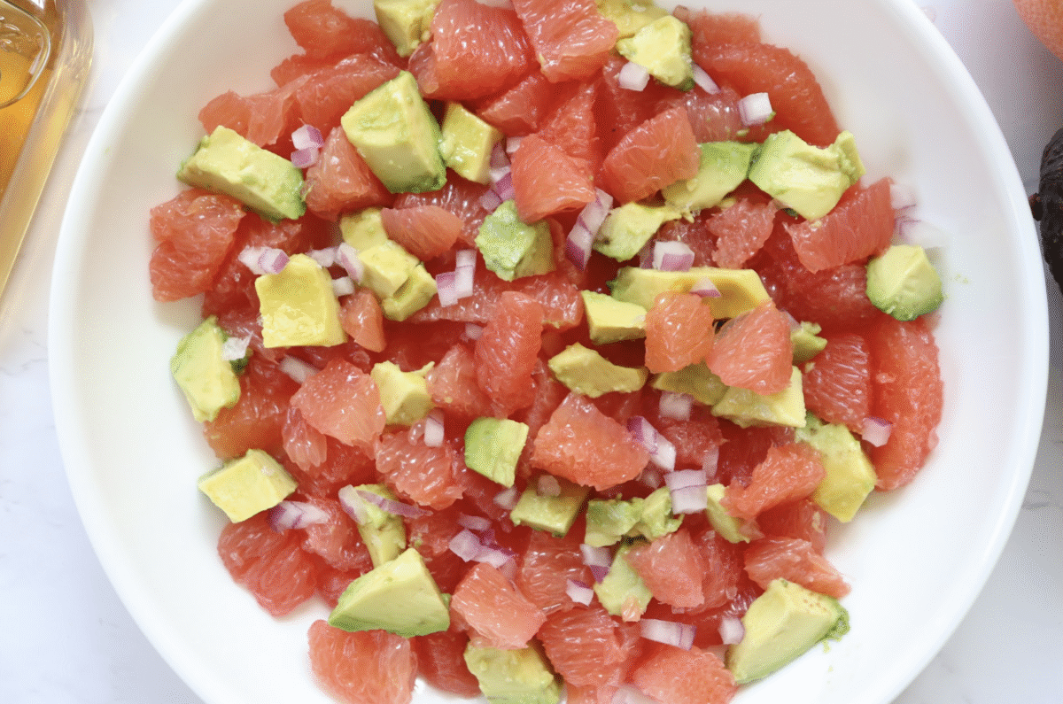 Citrus Avocado Salad with balsamic dressing in a serving bowl.