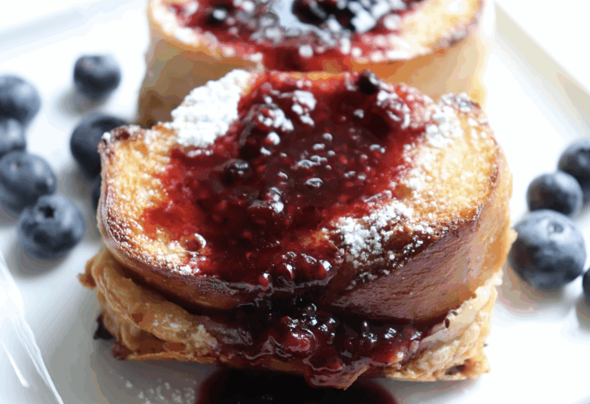 Stuffed french toast with raspberry syrup and fresh blueberries