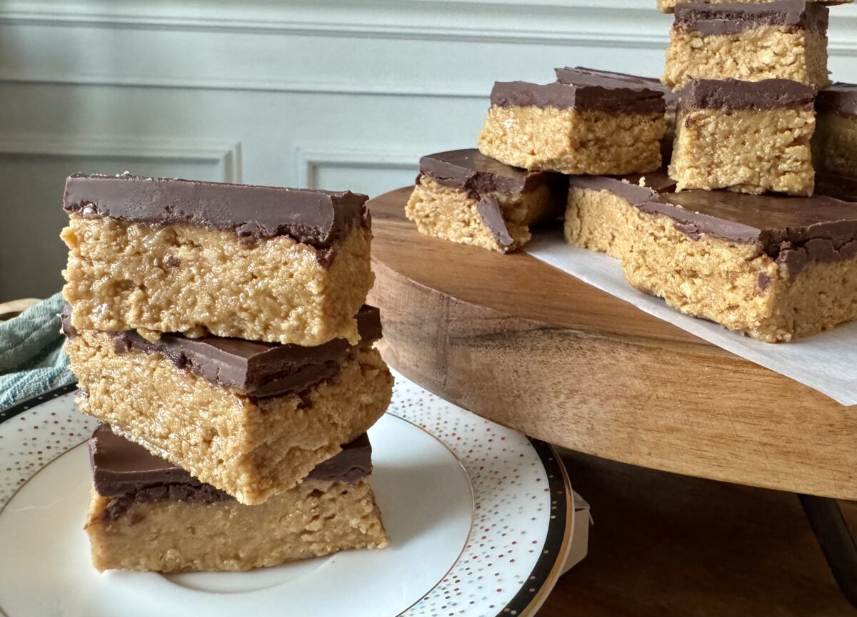 no bake peanut butter bars stacked on a wooden platter