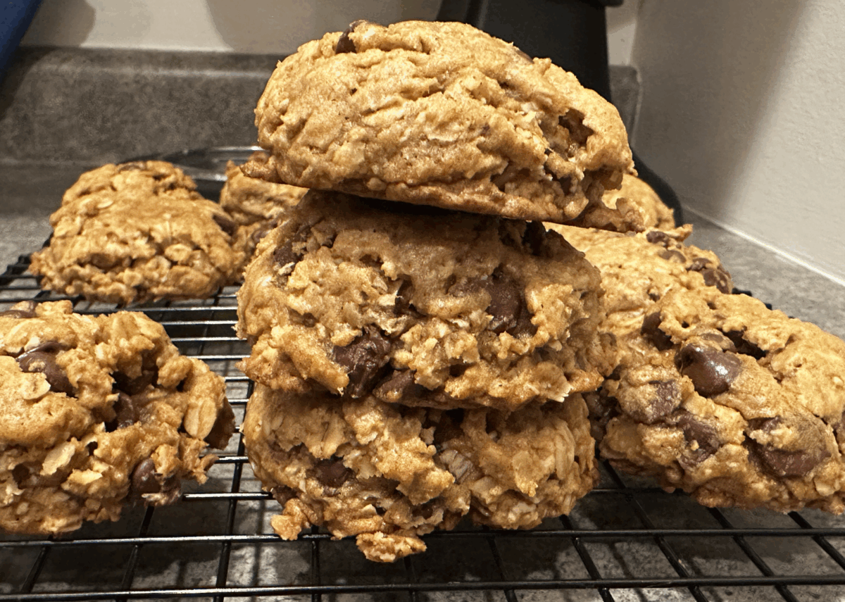 pumpkin oatmeal chocolate chip cookies stacked on a cooling rack.