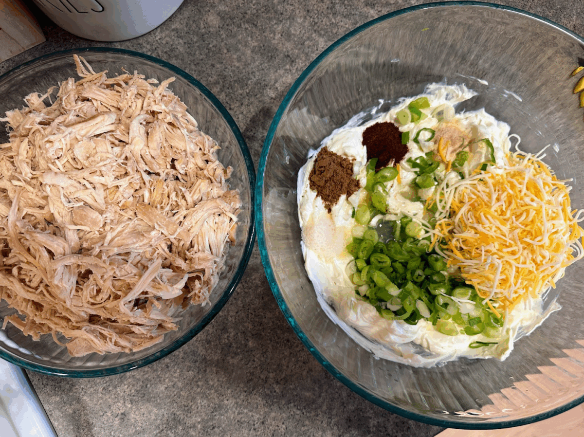 two bowls on a counter, one filled with shredded chicken and the other with creamy taquito filling