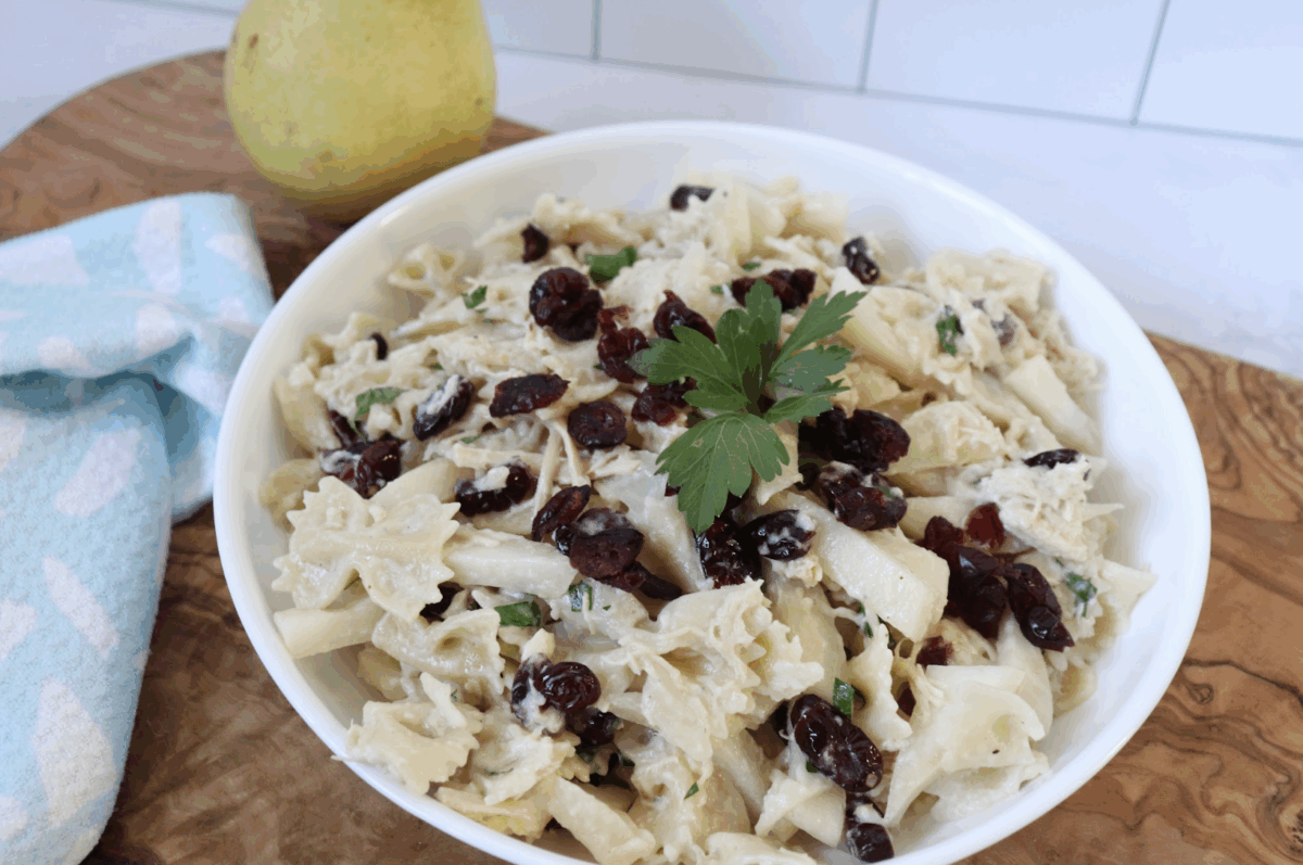 creamy chicken pasta with pears and cranberry in a serving bowl