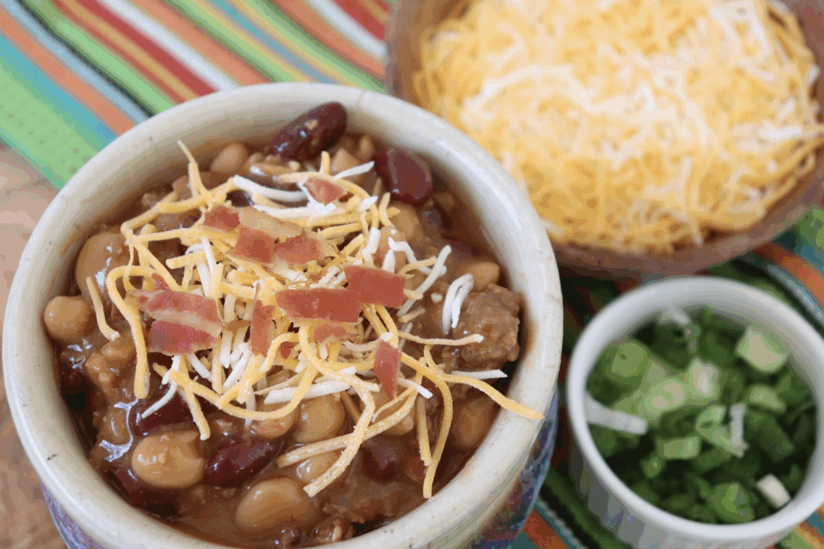 sweet chili lin the crockpot in a serving bowl with an assortment of toppings