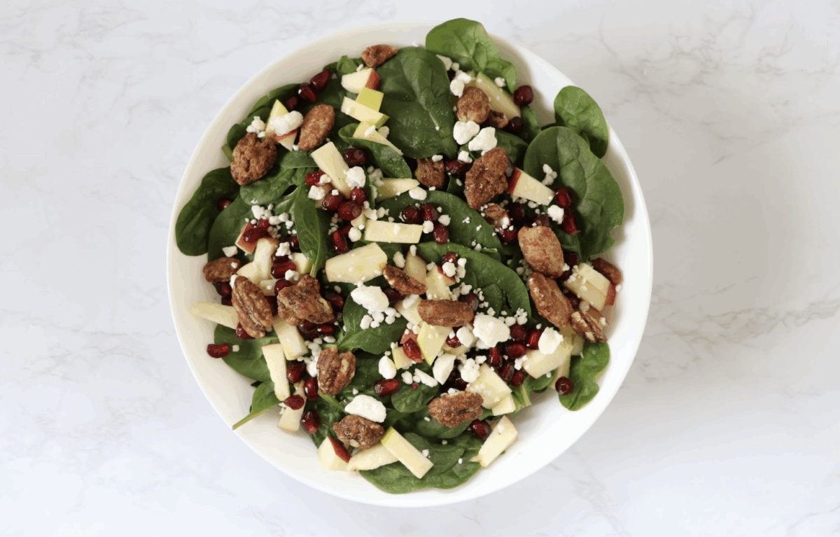 spinach salad with candied pecans, apples, feta and pomegranate