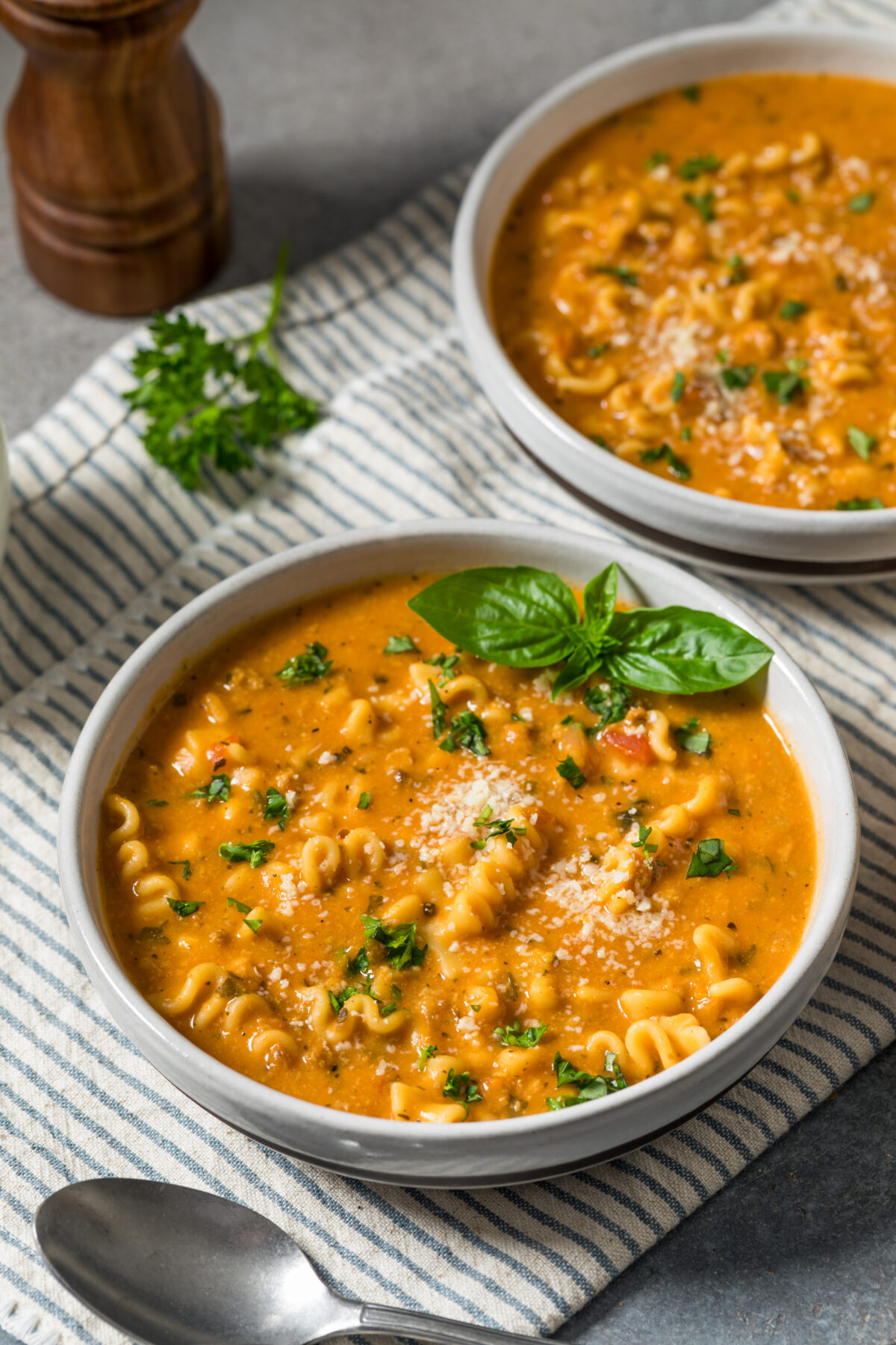 lasagna soup in serving bowls topped with fresh basil