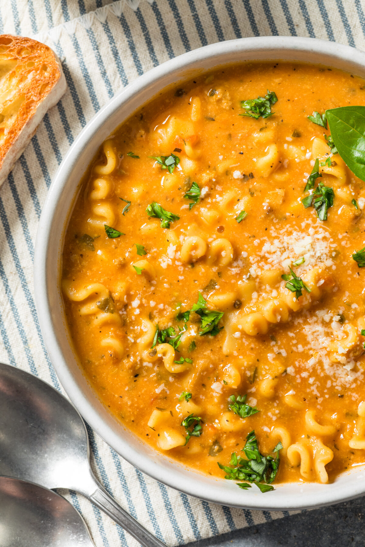 creamy italian soup with parmesan on a striped linen