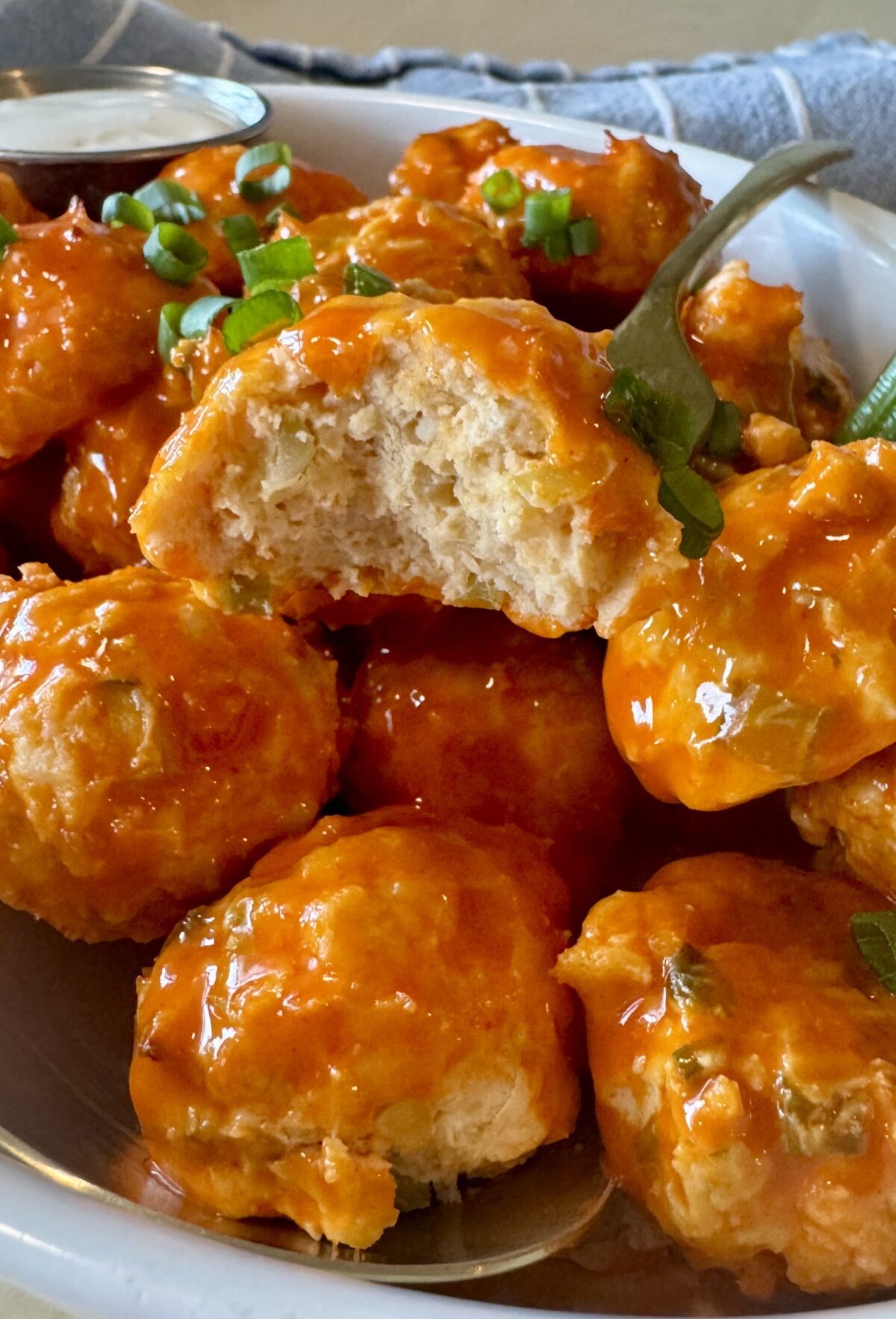 buffalo chicken meatballs in a serving dish with a fork