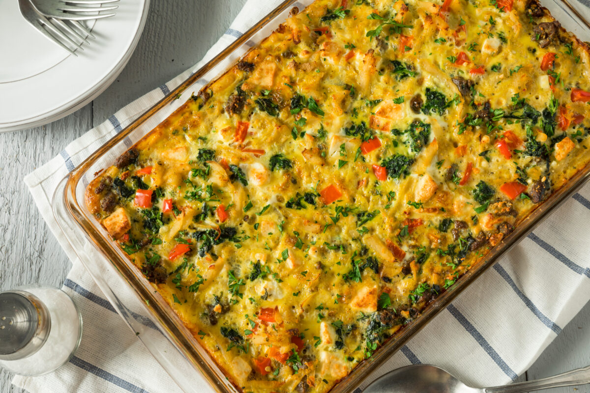 brunch egg and veggie bake in a casserole dish with a striped linen