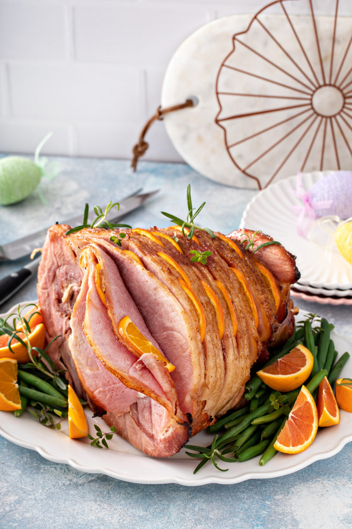 Easter ham stuffed with orange slices and herbs, spiral sliced glazed ham