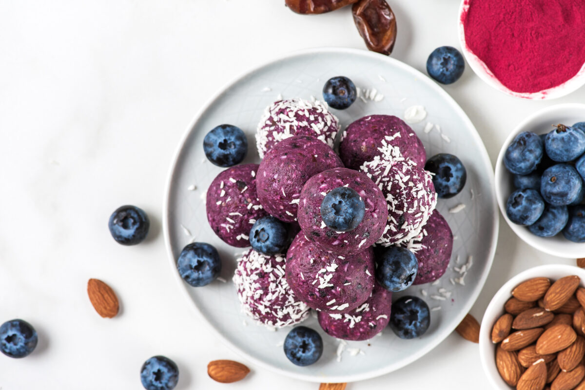 no bake blueberry acai energy bites or bites with fresh berries. top view. Healthy vegan snacks