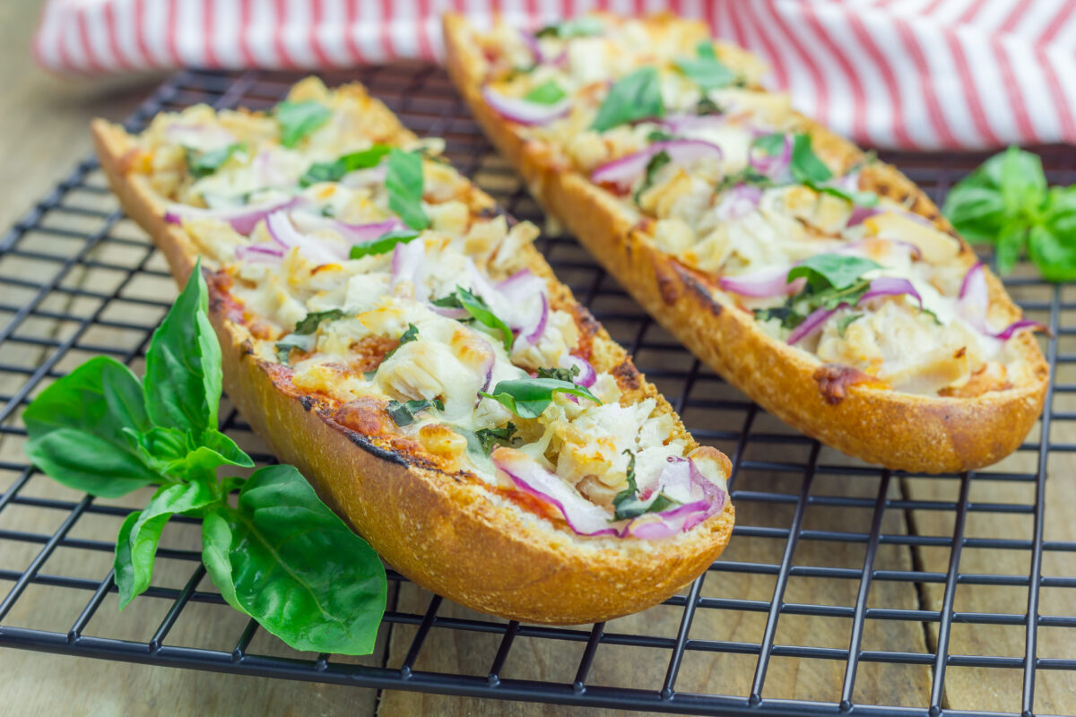 french bread bbq chicken pizza with fresh basil on a cooling rack