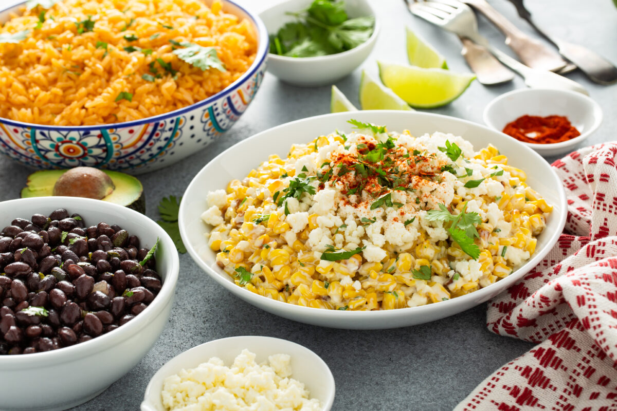 Mexican street corn, elote with cotija cheese, fresh cilantro and chili served wtih rice and black beans