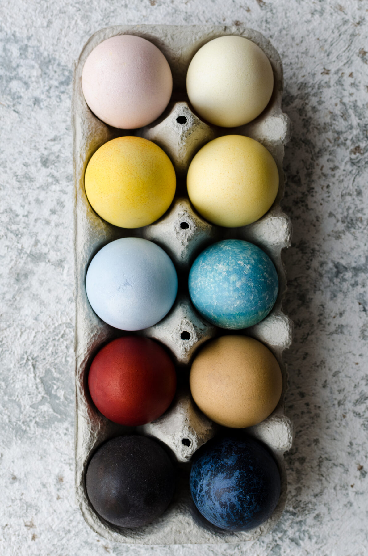 Easter eggs painted with natural egg dye from fruits and vegetables. Homemade naturally dyed Easter eggs. 
