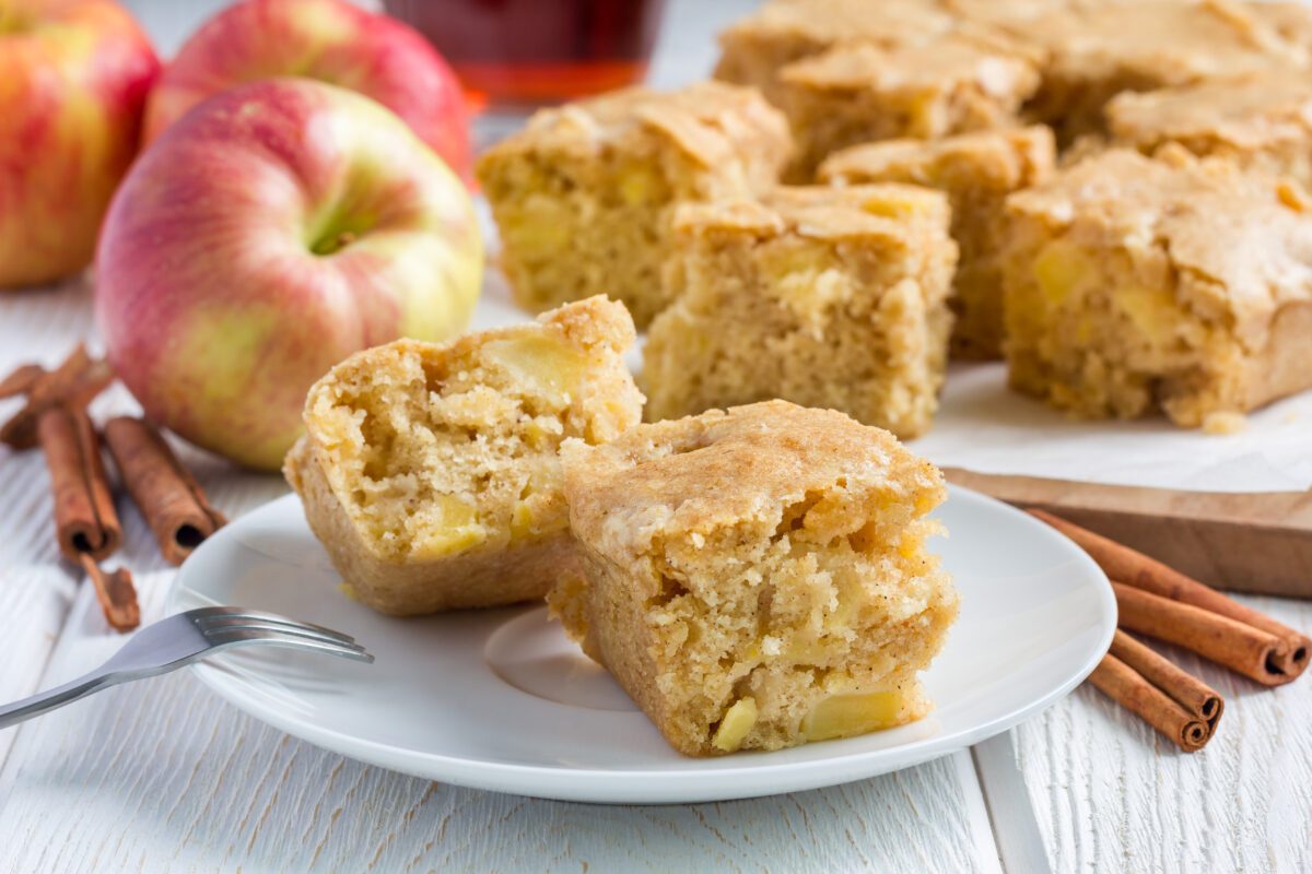 Homemade apple blondies cut into squares on a serving plate