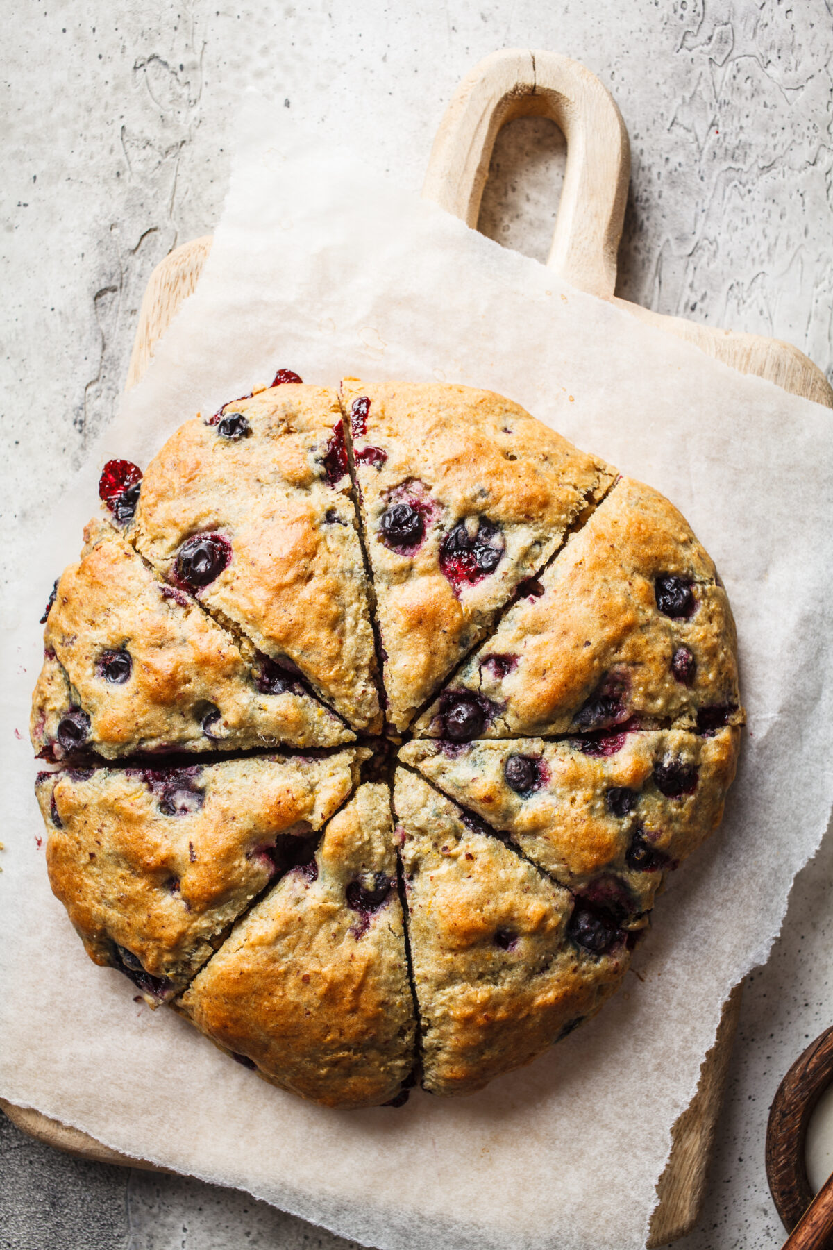 homemade blueberry scones shaped in a disc and cut into scones 