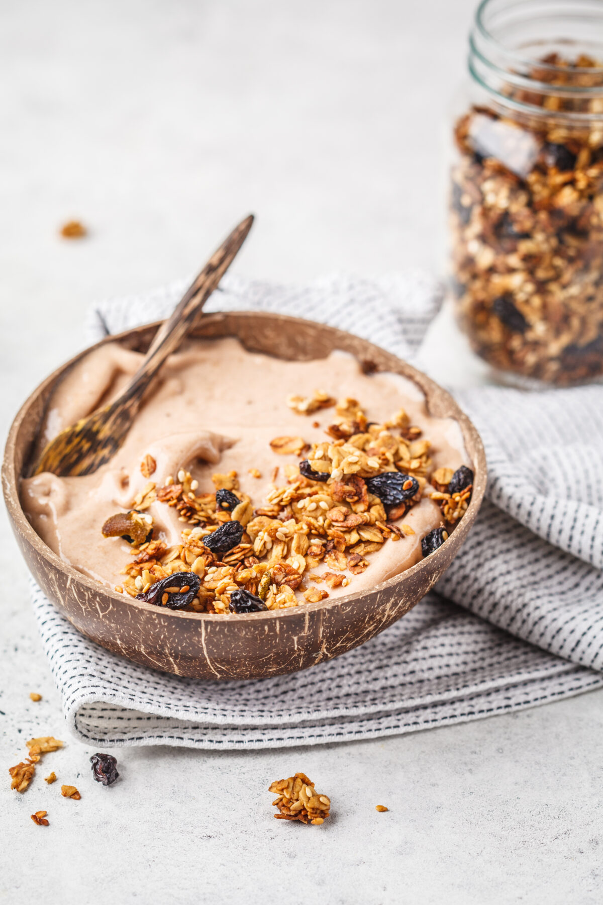 Chocolate smoothie bowl with granola in a coconut bowl. 