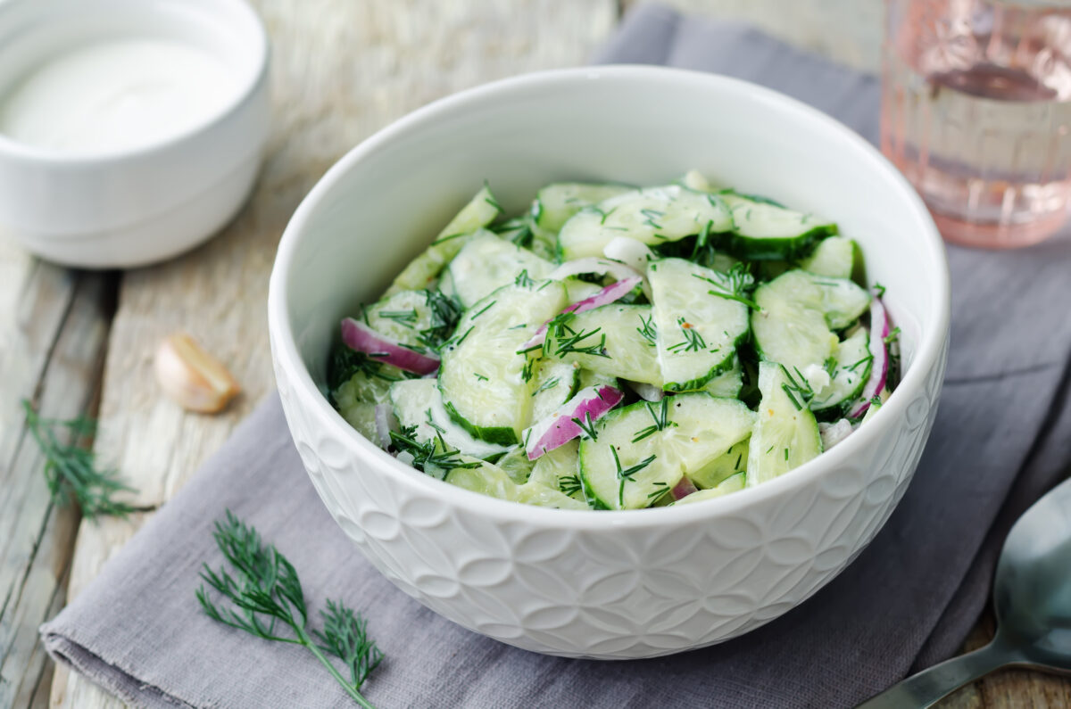 Creamy cucumber salad with fresh dill in a serving bowl