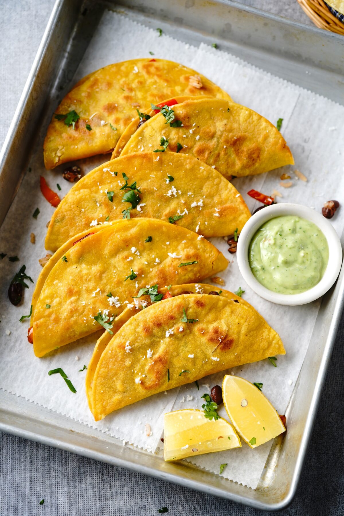 crispy oven baked black bean tacos on a baking sheet