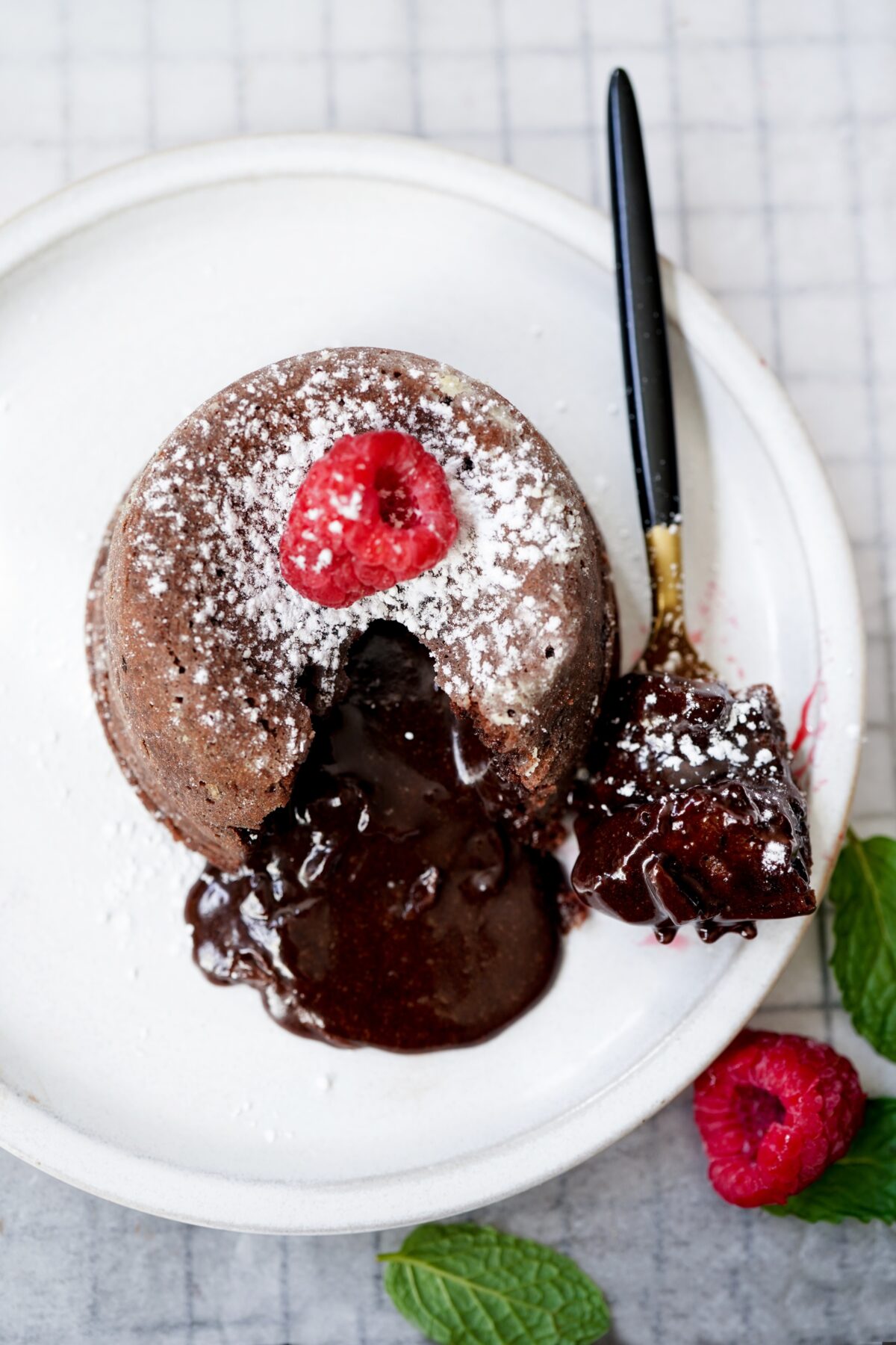 Homemade Chocolate molten lava cake served with raspberries and powdered sugar