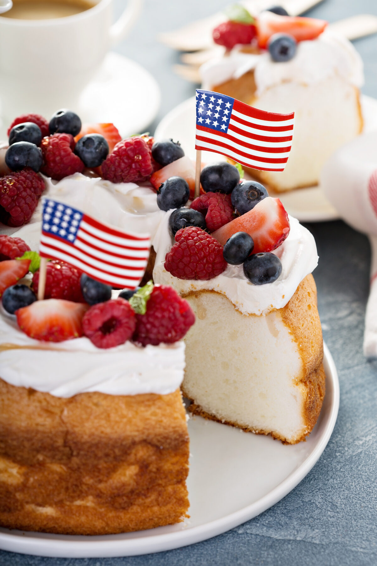 Angel food cake with whipped cream and berries for 4th of July