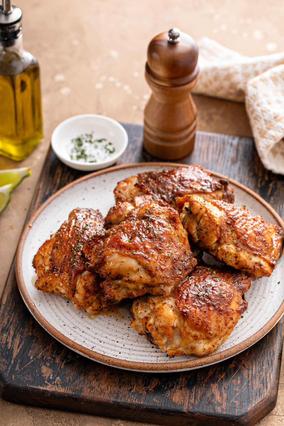 Chicken thighs roasted or air fried with paprika, spices rub and lime on a plate