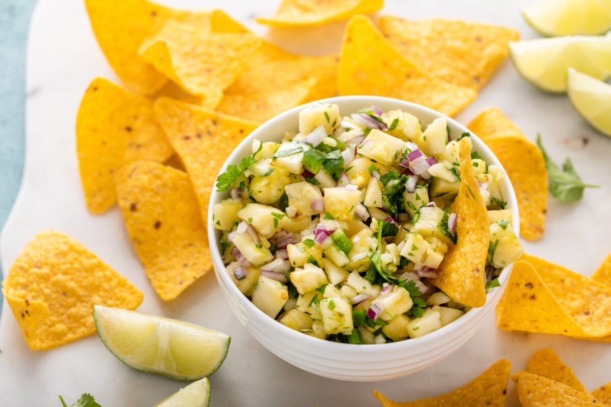 Pineapple salsa with cilantro, jalapeno and red onion served with corn tortilla chips and lime wedges