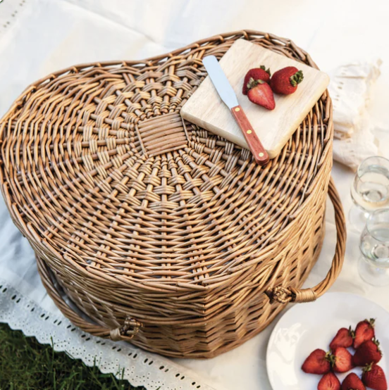 a heart shaped picnic basket with a plate of fresh strawberries