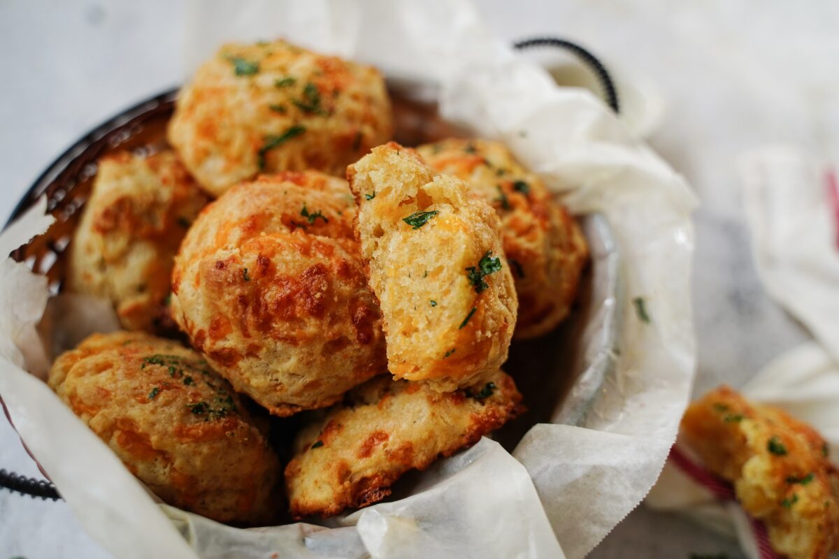Homemade Cheddar Biscuits with Chive Butter in a Basket