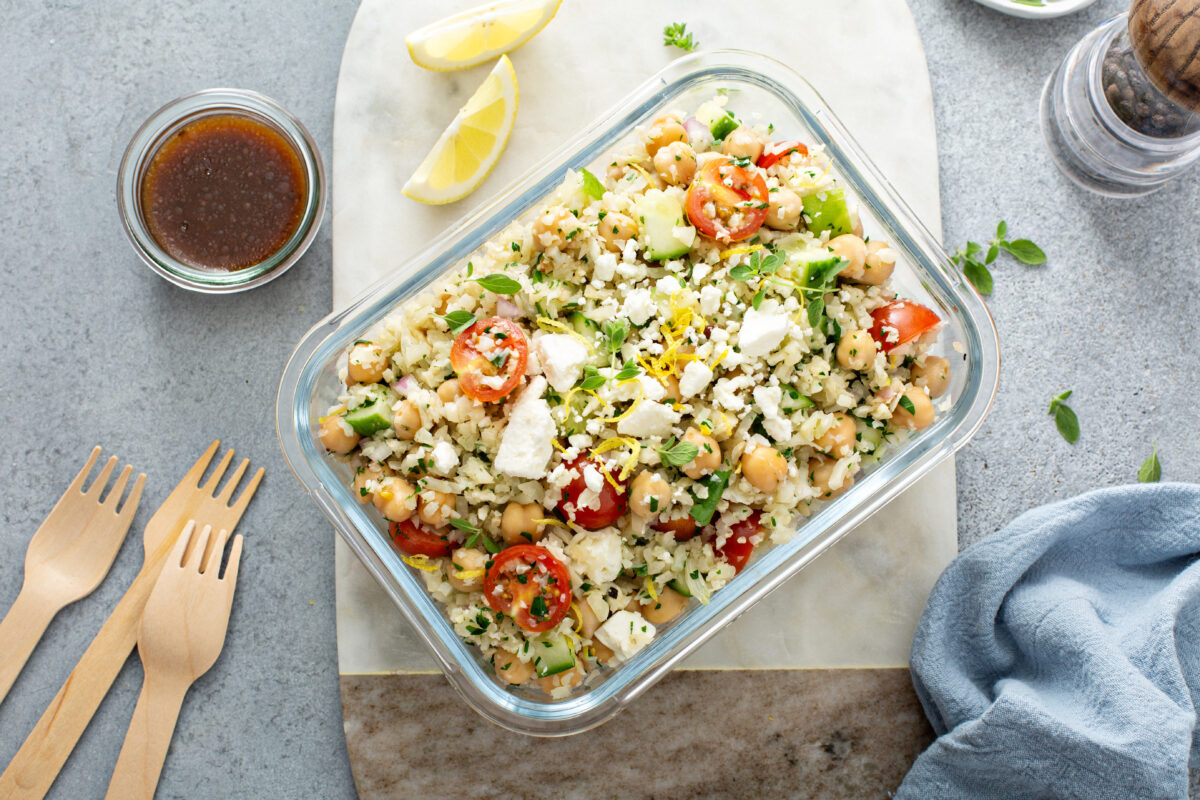 Greek Couscous Salad in a meal prep container and 