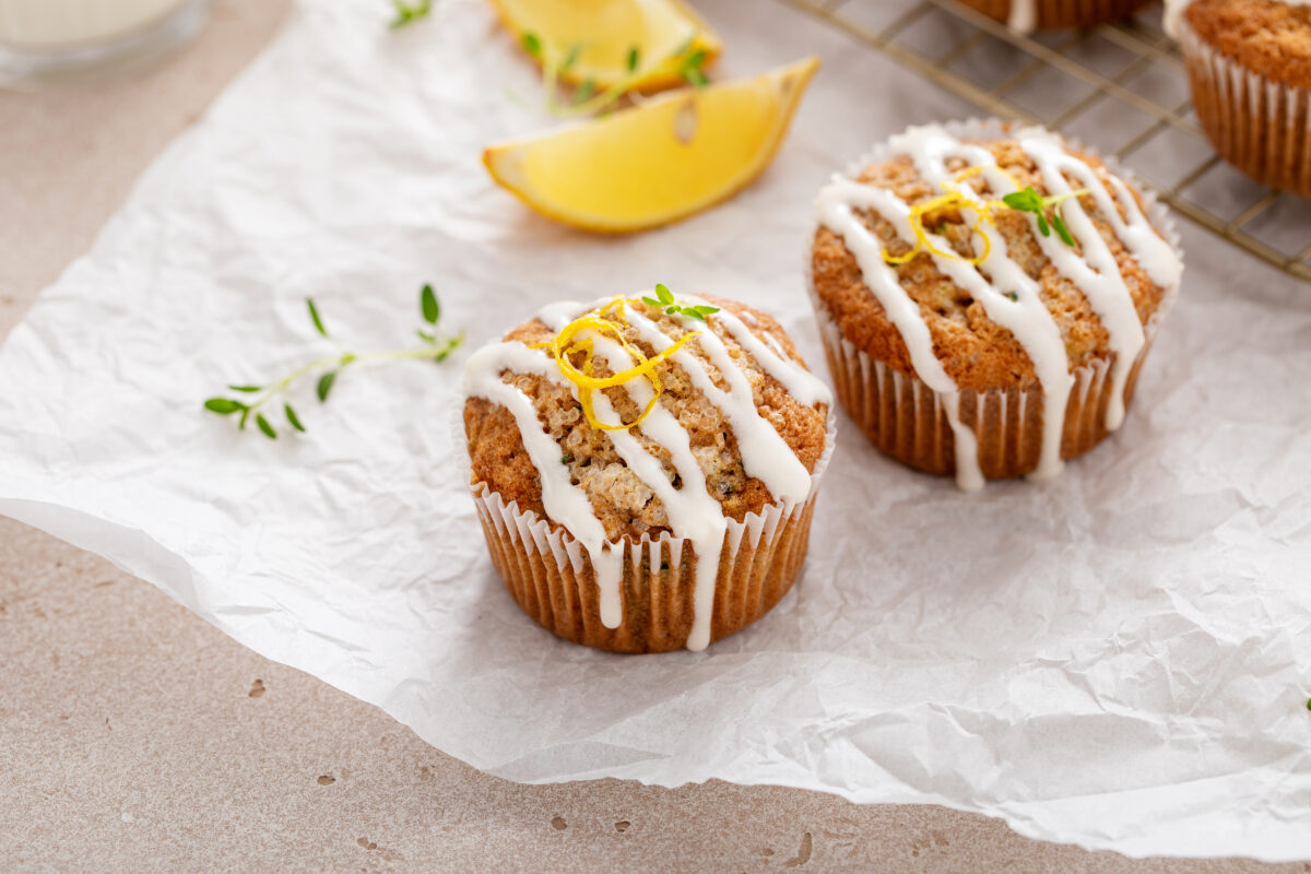 Lemon zucchini muffins with thyme and drizzled with cream cheese glaze