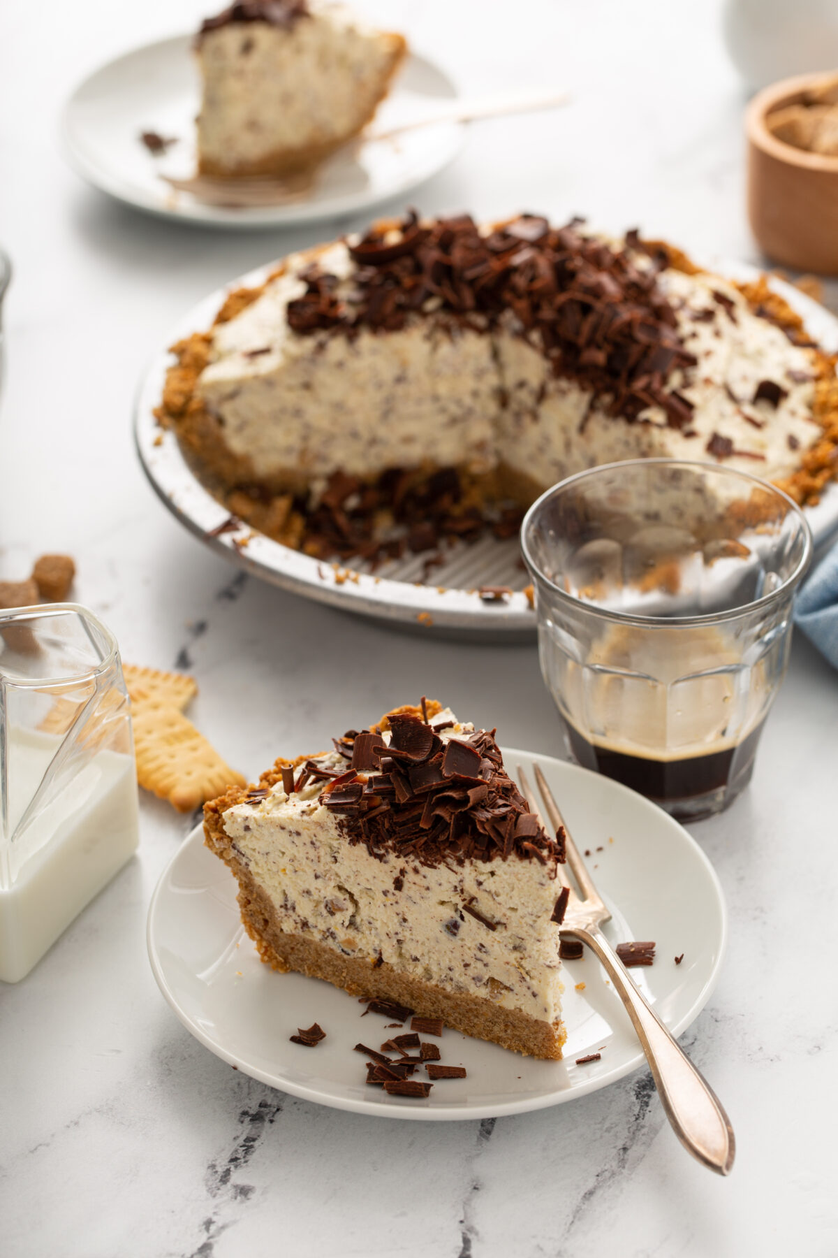 toffee ice cream pie with biscoff cookie crust and topped with chocolate shavings