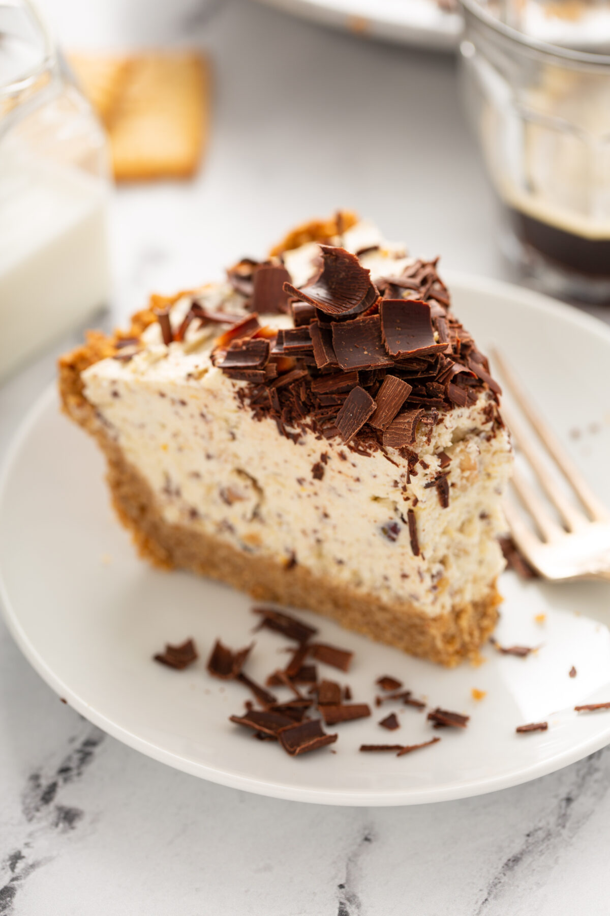 A slice of toffee ice cream pie with chocolate shavings