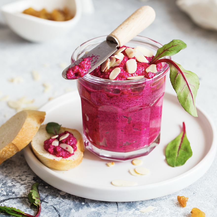 Bruschetta with Beetroot hummus decorated with chopped nuts and microgreen.