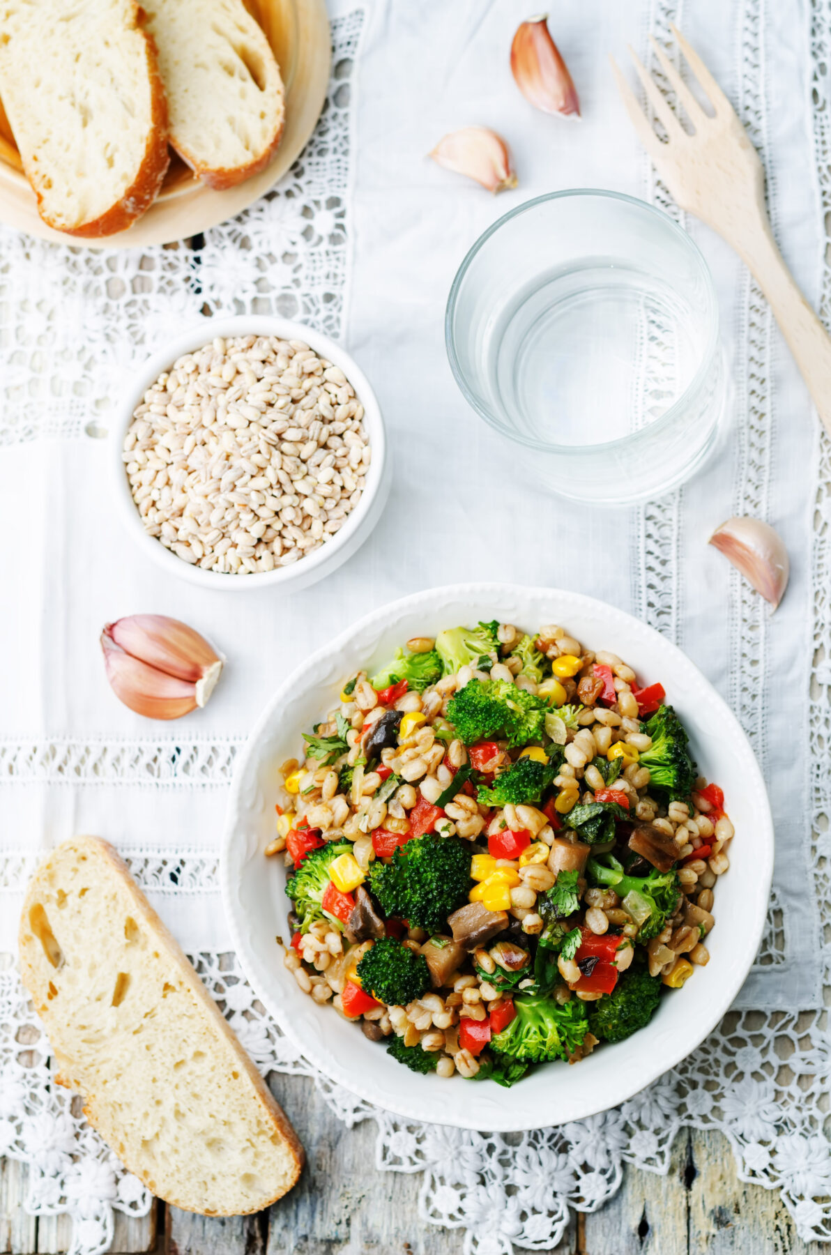 barley salad with roasted vegetables with a side of sliced bread