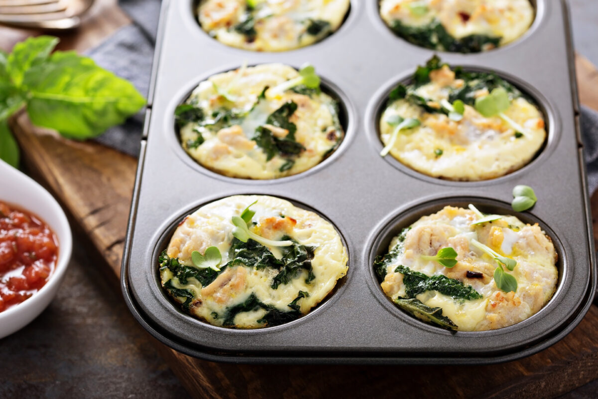chicken and kale high protein egg muffins in a tin 