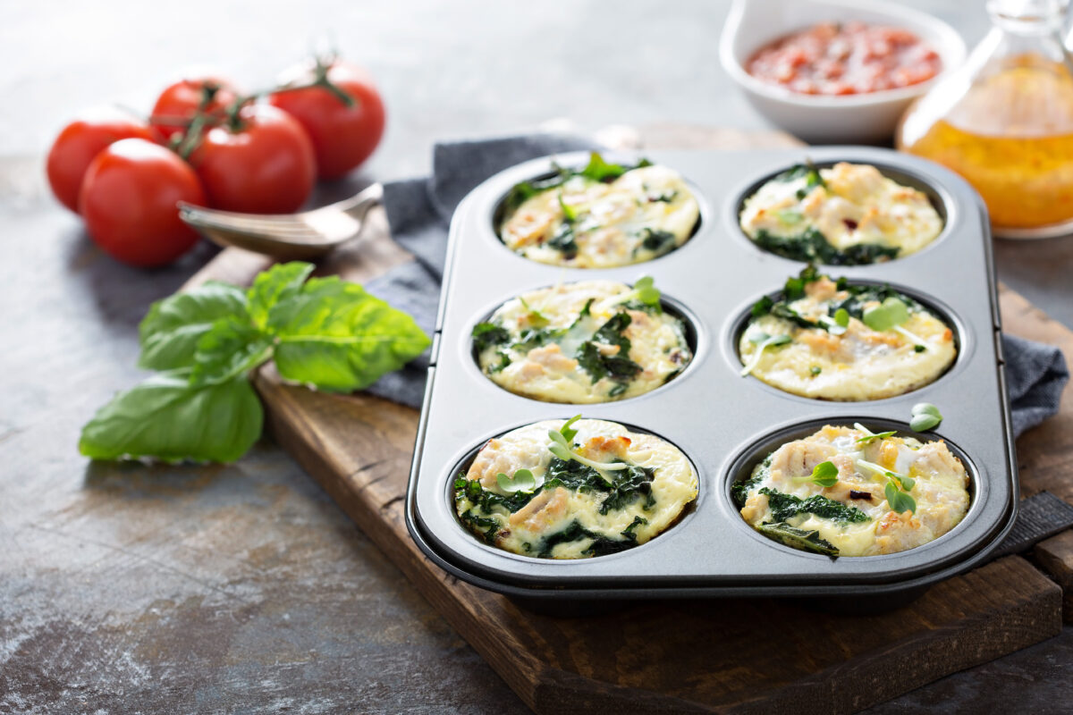 high protein egg cups with kale and chicken in a muffin tin
