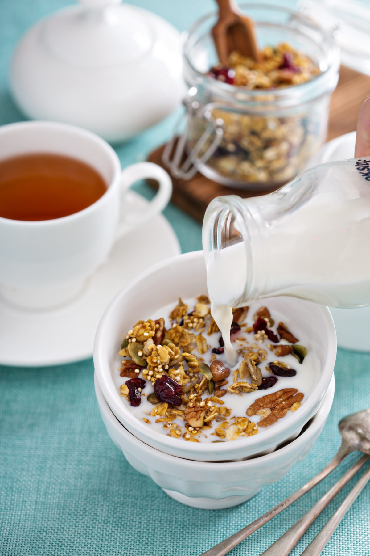 homemade granola in a bowl with milk poured over it