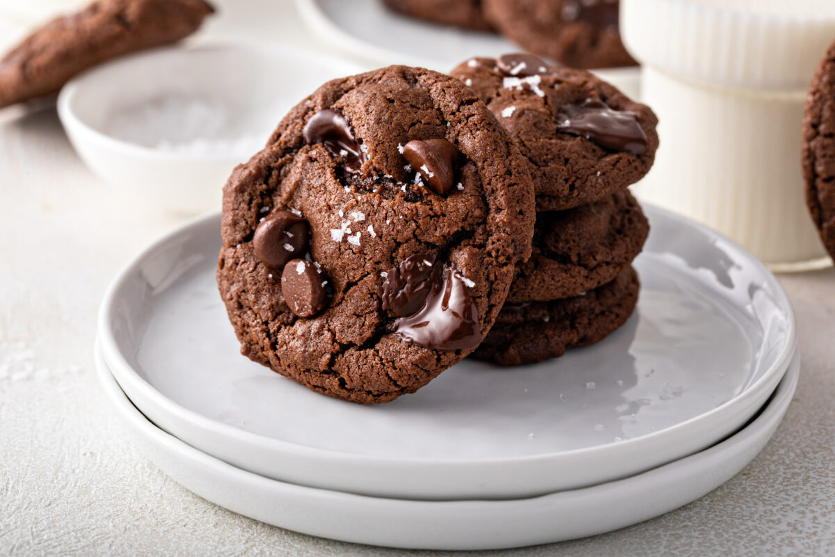 Double chocolate cookies with dark chocolate chips and salt flakes with a glass of milk