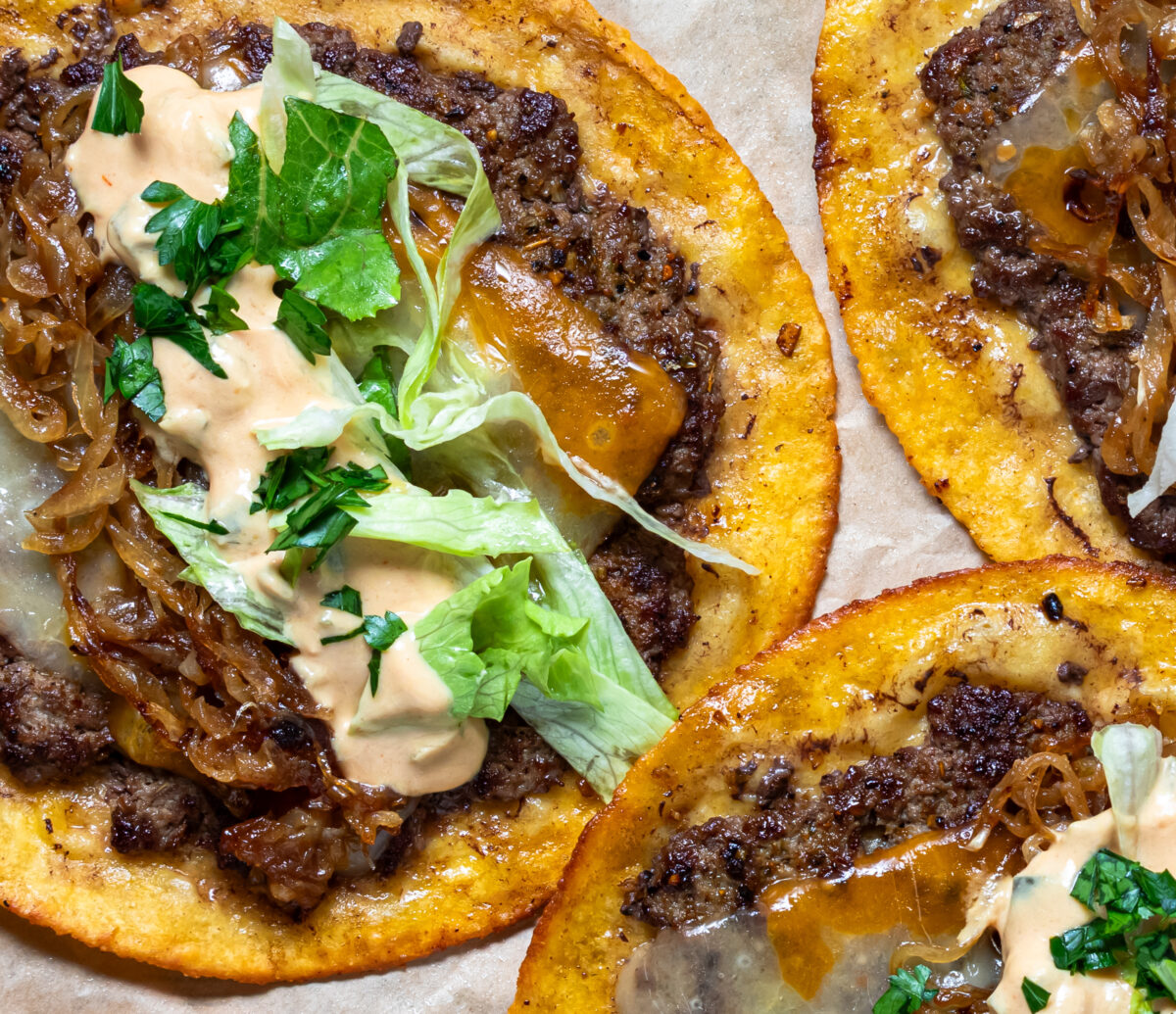 Top down close up look at tasty smash burger tacos with all the fillings.