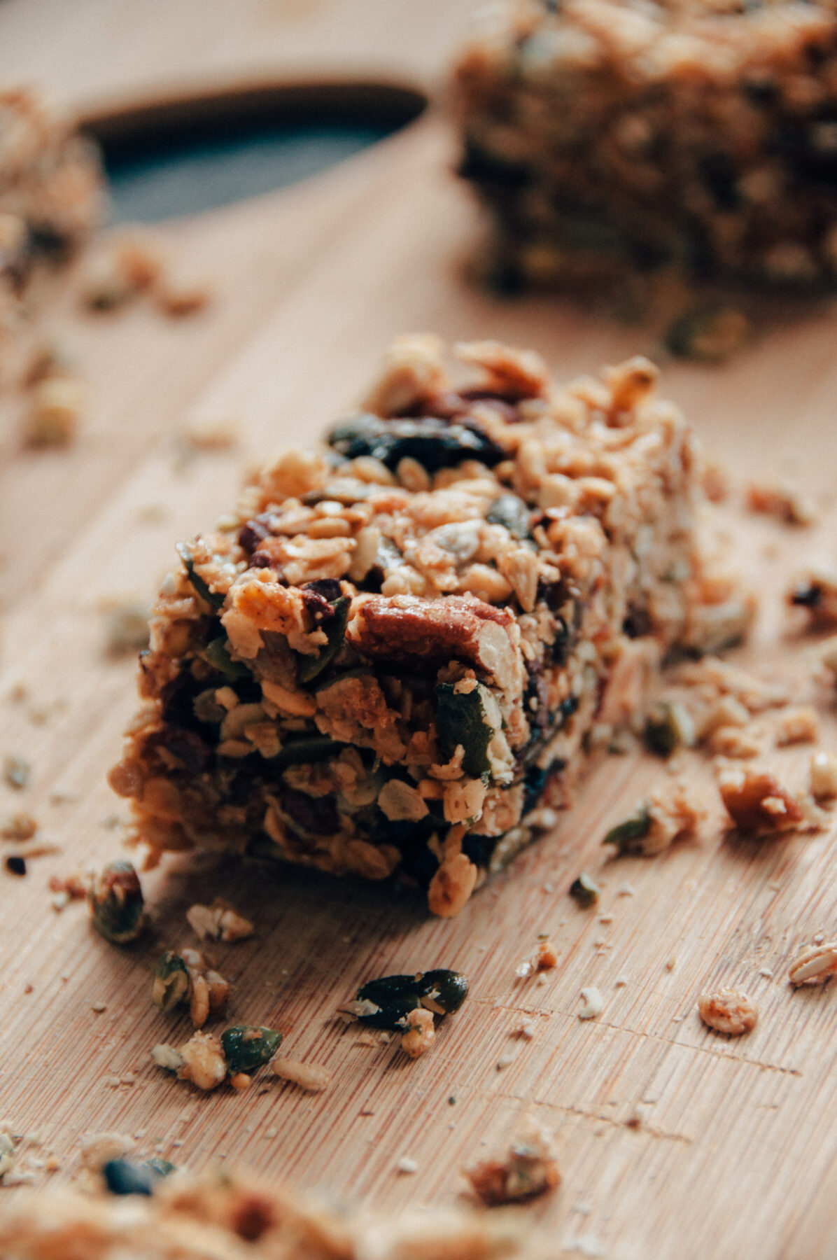 a trail mix granola bar on a wooden cutting board