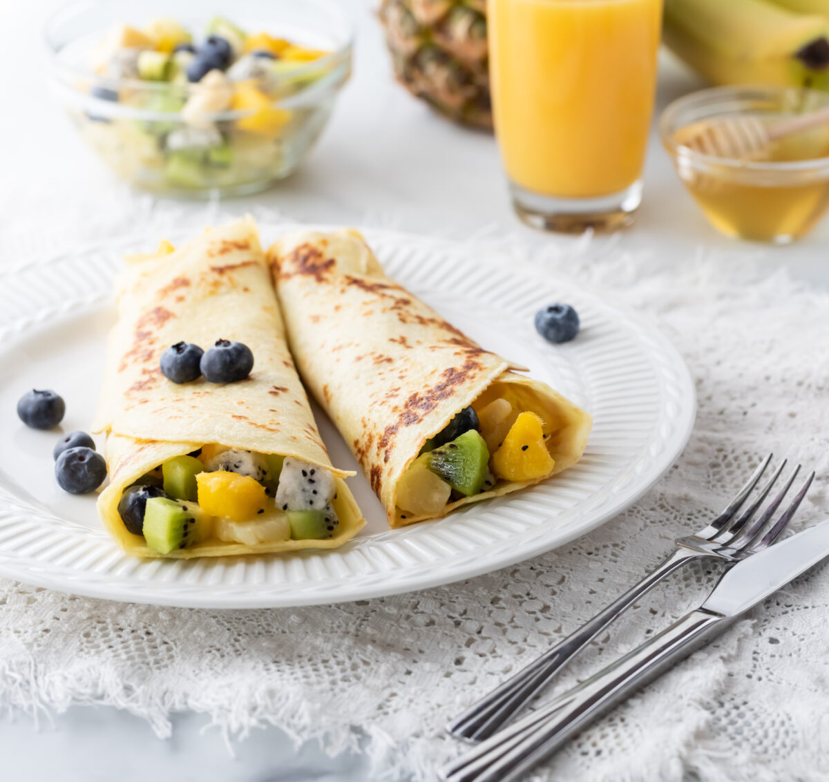 Delicious tropical fruit crepes with mango, pineapple and kiwi