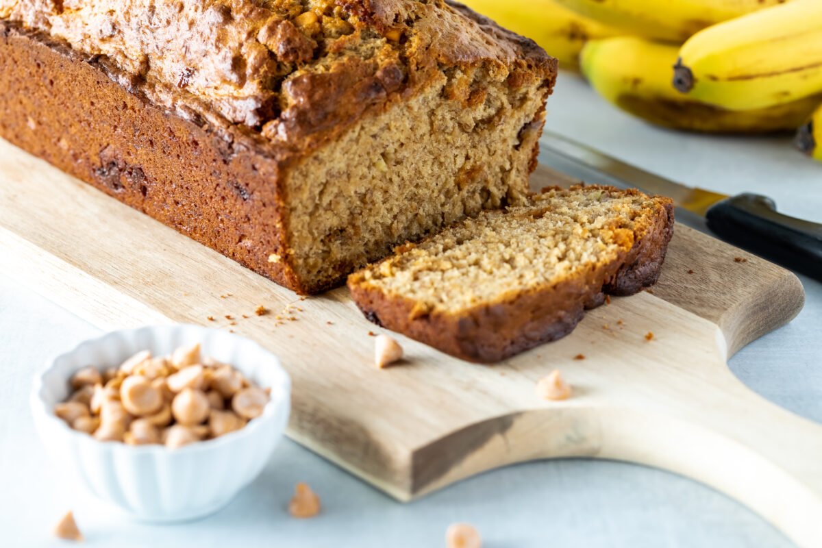 A delicious freshly baked butterscotch chip banana bread, sliced into and ready for eating.