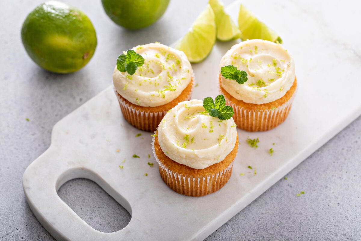 coconut lime cupcakes with lime and coconut garnished with mint leaf